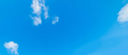 blue sky with white, soft cloudsの写真素材