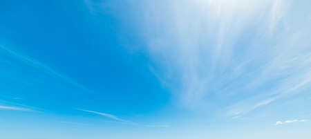 blue sky with white, soft cloudsの写真素材