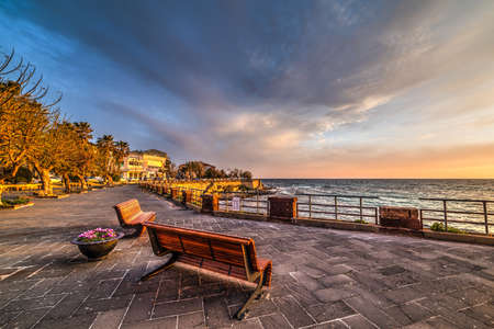 Wooden benches in Alghero seafront, Sardiniaの写真素材