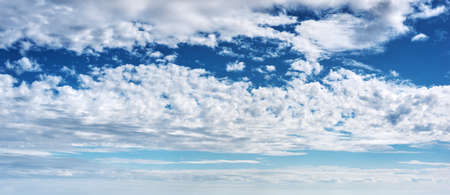 blue sky with white, soft cloudsの写真素材