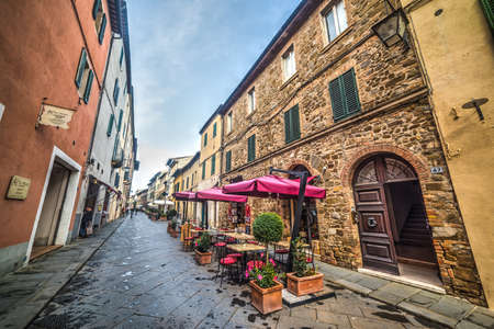 Montalcino, Italy - October 14, 2016: Tables and chairs in a narrow streetのeditorial素材
