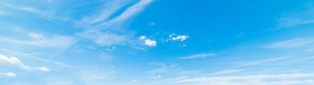 Blue sky with white, soft cloudsの写真素材