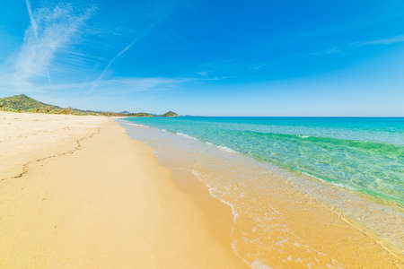 Turquoise water and golden shore in Cala Sinziasiの写真素材