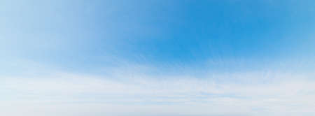 Blue sky with white, soft cloudsの写真素材