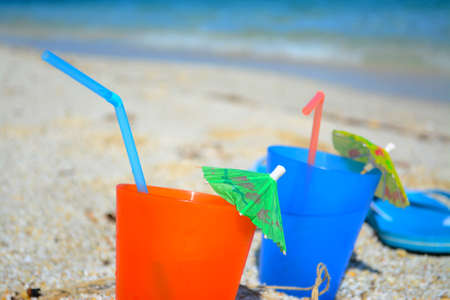Summer drink on the beach under a clear skyの写真素材