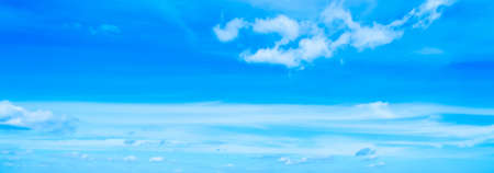 blue sky with white, soft cloudsの写真素材