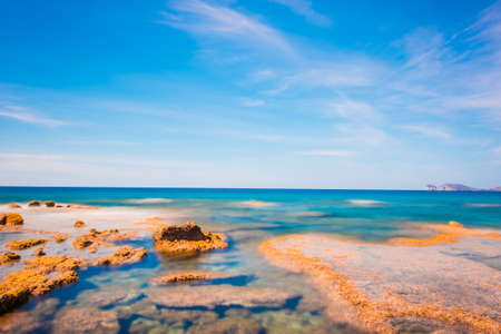 Orange rocks and blue sea in Alghero coast. Sardinia, Italyの写真素材