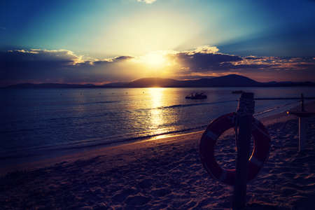 Life buoy by the sea at a scenic sunset. Sardinia, Italyの写真素材