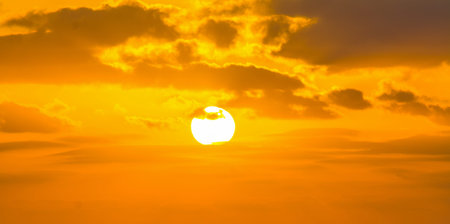 Sun shining through the clouds at sunset. Sardinia, Italy