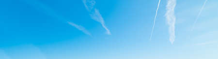 blue sky with white, soft cloudsの写真素材