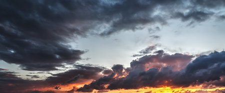 Dark clouds and orange sky at sunset