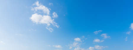blue sky with white, soft cloudsの写真素材