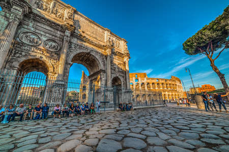 Rome, Italy - October 12, 2017: Tourists by Arch of Constantine with Coliseum on the backgroundのeditorial素材
