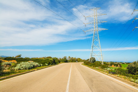 High voltage tower by the edge of a country roadの写真素材