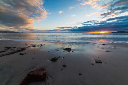 Rocks and sand in Alghero at sunset. Sardinia, Italyの写真素材