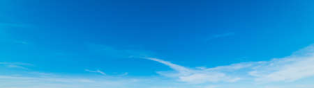 Blue sky with white, soft cloudsの写真素材