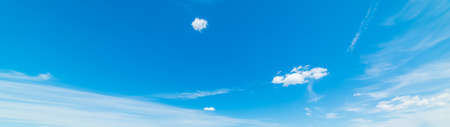 blue sky with white, soft cloudsの写真素材