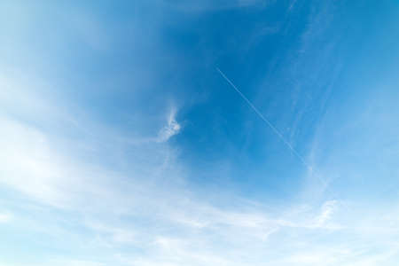 blue sky with white, soft cloudsの写真素材