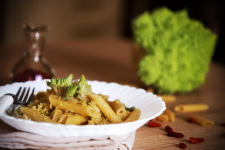 Close up of a pasta with roman cauliflower plate on a wooden tableの写真素材