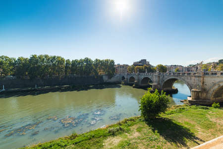Sun shining over Sant Angelo bridge in Rome, Italyの写真素材