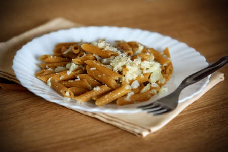 Close up of a pasta and cauliflower dish on a wooden tableの写真素材