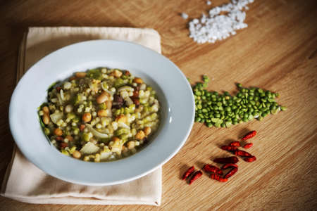 Beans and fregola soup on a wooden tableの写真素材