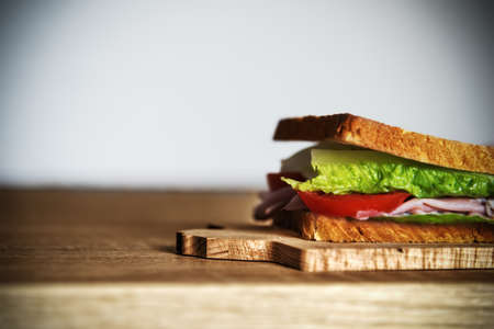 Close up of a sandwich on a wooden table の写真素材