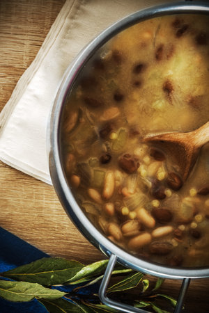 Fregola and beans soup in a metal pot seen from above