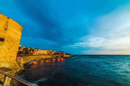 Alghero seafront on a cloudy day at sunset. Sardinia, Italyの写真素材