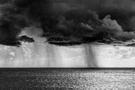 Shower rain over the sea in black and white effect. Sardinia, Italyの写真素材