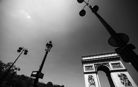 World famous Arch de Triomphe under a shining sun. Paris, France
