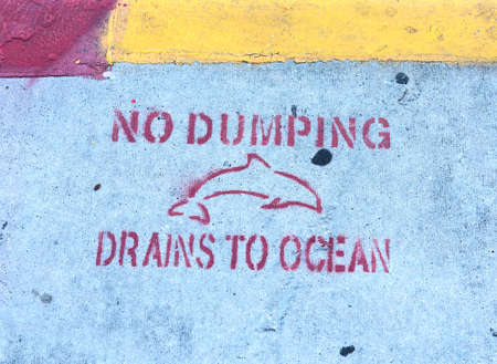 No Dumping Drains To Ocean writing on the sidewalk in Key West. Southern Florida, USAの写真素材