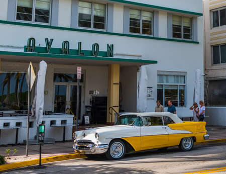 Miami Beach, USA - february 26, 2019: Yellow and white Oldsmobile Rocket 88 parked by Avalon Hotel on Ocean Driveのeditorial素材