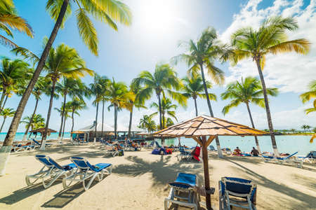 Beach chairs and parasol in Bas Du Fort beach in Guadeloupe, French west indies. Lesser Antilles, Caribbean seaの写真素材