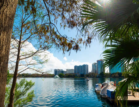 Orlando, USA - February 23, 2019: Swan pedal boats in Lake Eola shore under a shining sunのeditorial素材