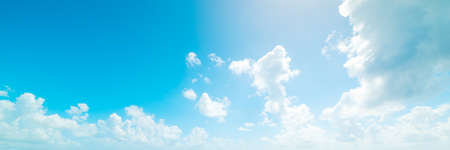 blue sky with white, soft cloudsの写真素材