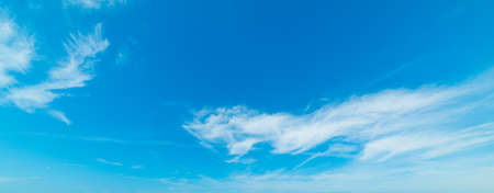 blue sky with white, soft cloudsの写真素材