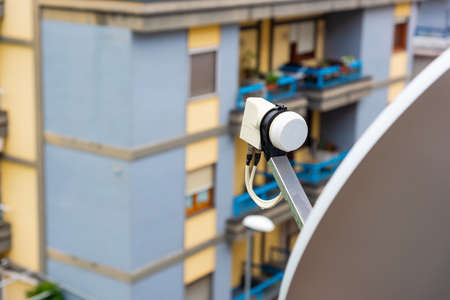 Close up of a satellite dish and LNB on a balconyの写真素材