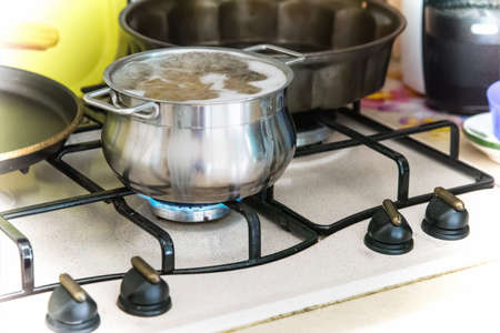 Close up of a metal pot with boiling water and pastaの写真素材