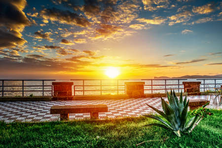 Sun shining over Alghero seafront at sunset. Sardinia, Italyの写真素材