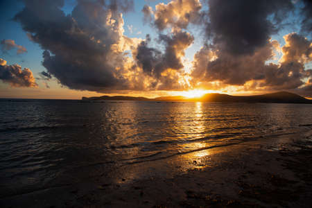 Dramatic sky over the sea at sunset. Alghero, Italyの写真素材