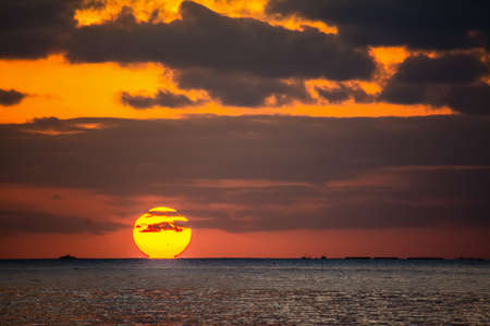 Dark clouds and shining sun over Alghero at sunset. Sardinia, Italyの写真素材