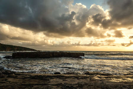 Dark clouds over Alghero shore at sunset. Sardinia, Italyの写真素材