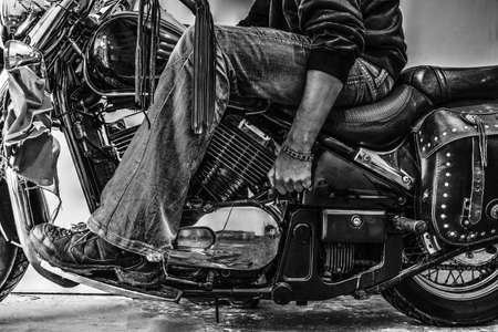 biker starting a classic motorcycle. Black and white effectの写真素材