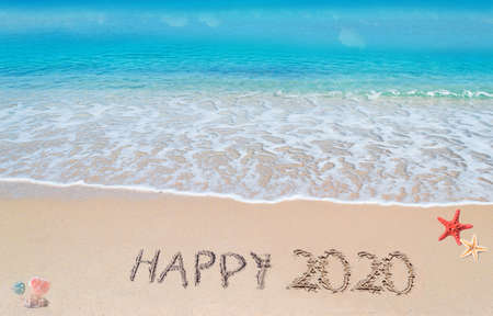 "happy 2020" written on a tropical beachの写真素材
