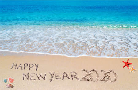 "happy new year 2020" written on a tropical beachの写真素材