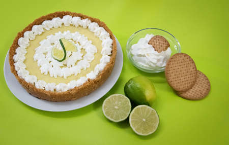Key Lime Pie with ingredients on a green backgroundの写真素材