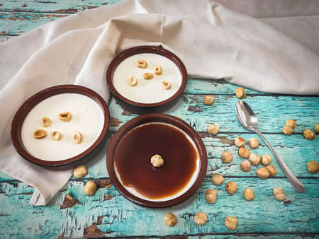 Panna cotta, caramel and hazelnuts seen from aboveの写真素材