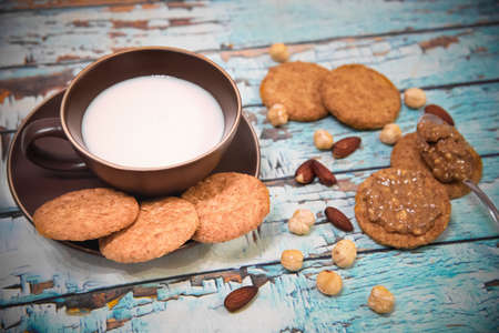 Almond milk, whole grain cookies and peanut butter for breakfastの写真素材