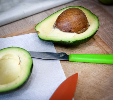 Avocado halves on the kitchen tableの写真素材